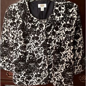 Jacket is by has three qtr. sleeves navy blue floral print on white